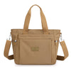 A tan nylon tote bag with brown straps and a secure zipper closure.