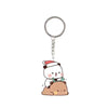 A cute cartoon character keychain charm featuring a white bear with a red Santa hat sitting on a brown animal.