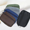 A stack of nylon mini coin purses and card holders in various colors, including olive green, gray, blue, and black.