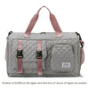 A gray nylon travel duffle bag with a quilted pattern and pink straps.