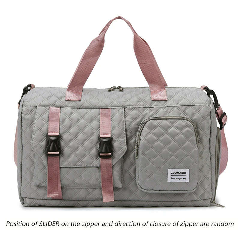A gray nylon travel duffle bag with a quilted pattern and pink straps.