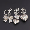 Silver bag charm keychain featuring a leopard print bow and heart charms