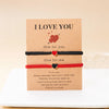 A card with the message I love you and three beaded bracelets for couples