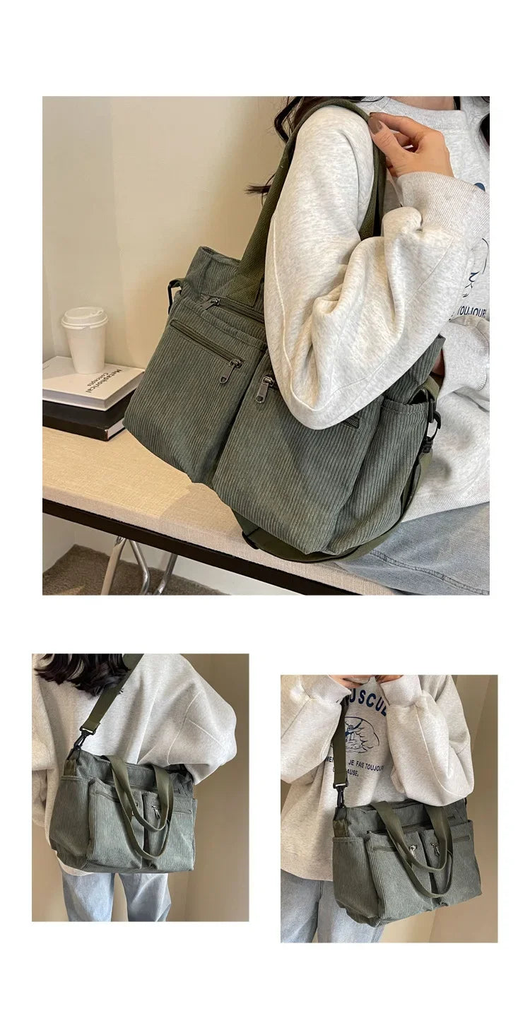A person is holding a dark olive green textured corduroy tote bag with adjustable straps against a light background.