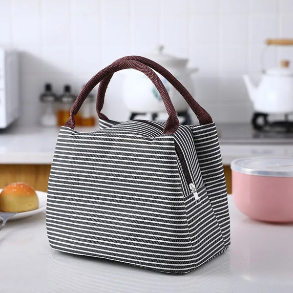 A black and white striped thermal lunch bag is displayed on a white surface.