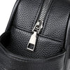 Close-up of a black PU leather clutch bag featuring a silver zipper detail.