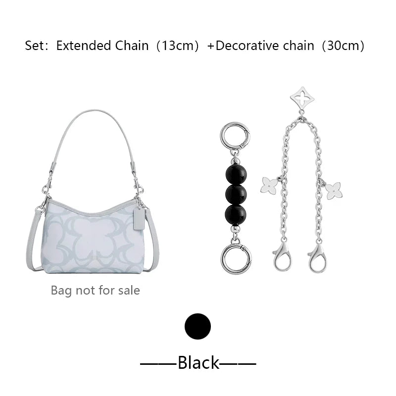 Silver extended and decorative chains with a white patterned bag and charms