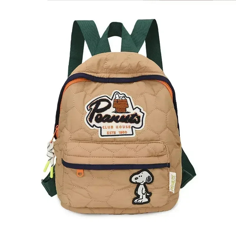 A tan canvas shoulder bag featuring a Snoopy cartoon design and green straps.