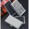 A collection of metal cigarette case holders and a box of tobacco products on a dark surface.