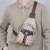 A man wearing a beige long-sleeved shirt with a brown crossbody sling bag attached to his chest.