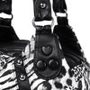 Close-up of a black and white leopard print PU leather tote bag with adjustable strap details.