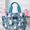 Bolsa térmica estampada en verde azulado y blanco con correas rosas, con un diseño de animal lindo.