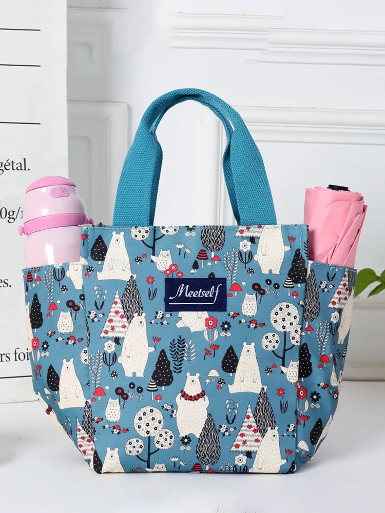 Bolsa térmica estampada en verde azulado y blanco con correas rosas, con un diseño de animal lindo.