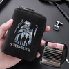 A black zippered card wallet featuring a supernatural silhouette design is held in a hand next to a stack of credit cards.