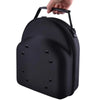 A black unisex travel baseball hat and storage bag being held by a hand.
