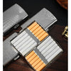 A silver metal cigarette case is open, displaying twelve orange-tipped cigarettes inside.