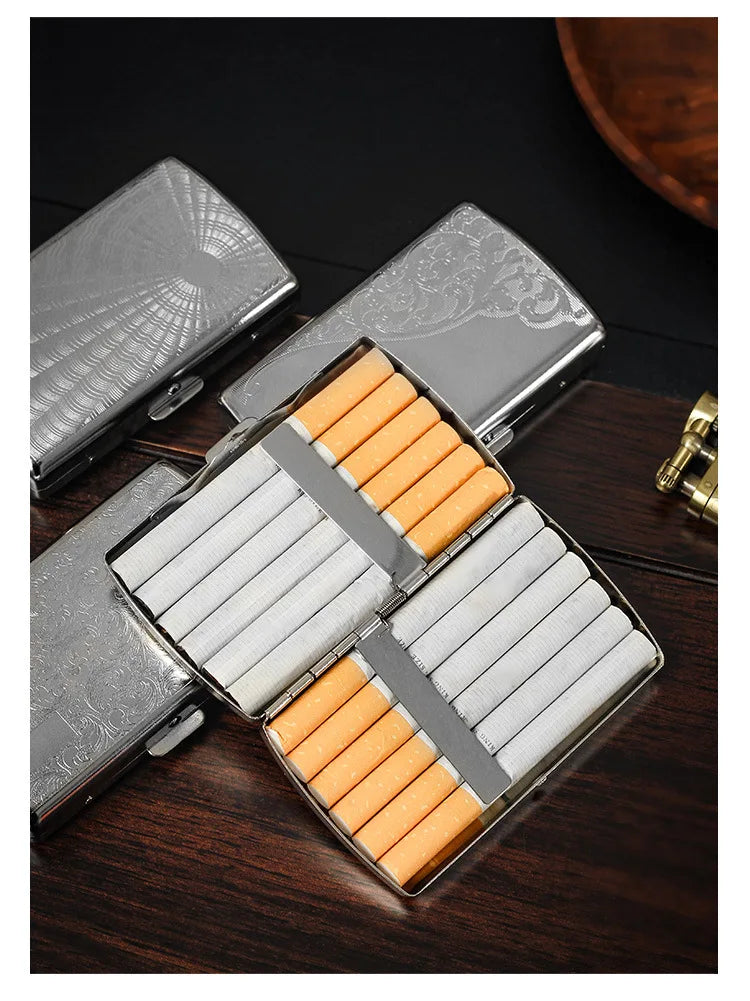 A silver metal cigarette case is open, displaying twelve orange-tipped cigarettes inside.