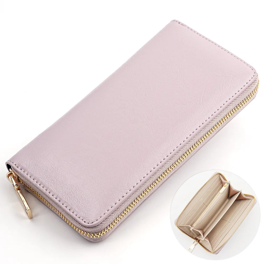 A light pink genuine leather zipper wallet shown in a diagonal view with a close-up inset.