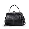 A black leather crossbody shoulder bag with a silver-toned chain and decorative clasp.
