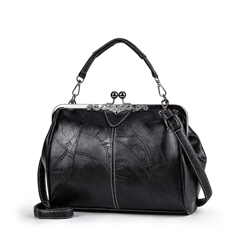 A black leather crossbody shoulder bag with a silver-toned chain and decorative clasp.