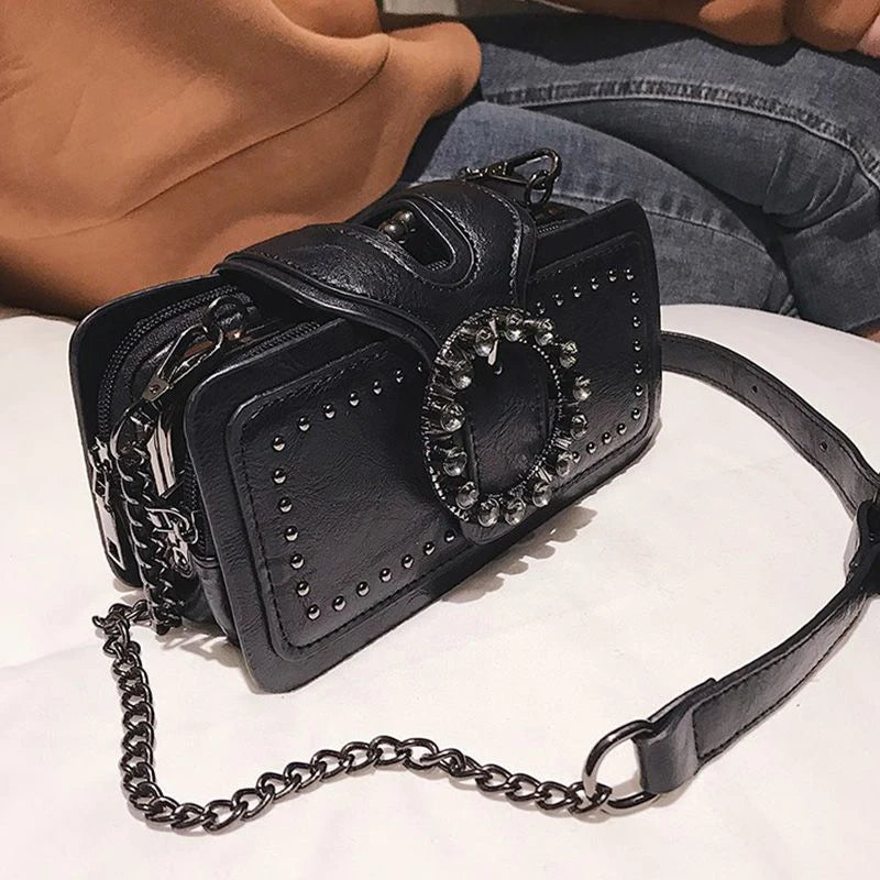 Black vintage PU leather crossbody bag with a rhinestone buckle and chain strap.