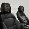 A pair of black silicone car headrest covers shown in a vehicle seat interior.