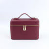 A maroon PU leather makeup bag with a gold zipper and carrying loop.
