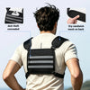 A man wearing a black waterproof and reflective chest pack on his back, demonstrating its fit.