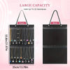 Black fabric jewelry organizer bag with multiple strands of necklaces for wall mounting