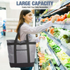 A woman holds a large gray insulated cooler bag while shopping in a grocery store refrigerator display.