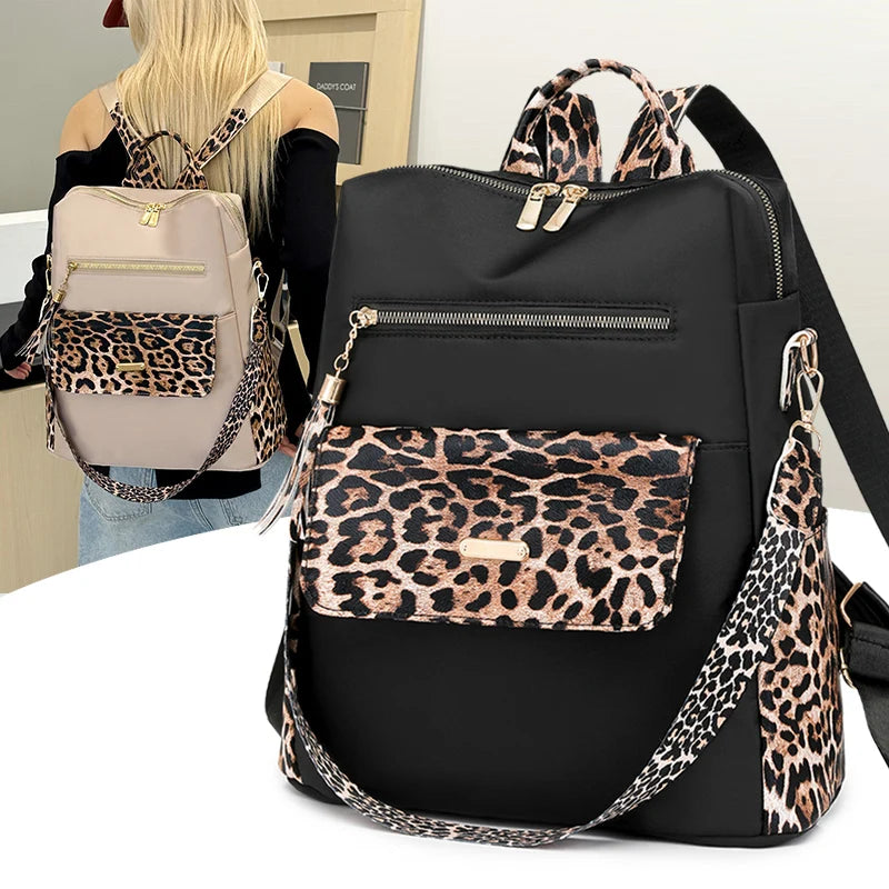 A black fashion backpack with leopard print accents and gold hardware, shown next to a person.