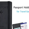 A black passport holder wallet with a leather cover and a blue document visible inside.