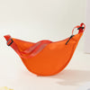 An orange women's preppy sling crossbody bag with a red strap is displayed on a light surface.
