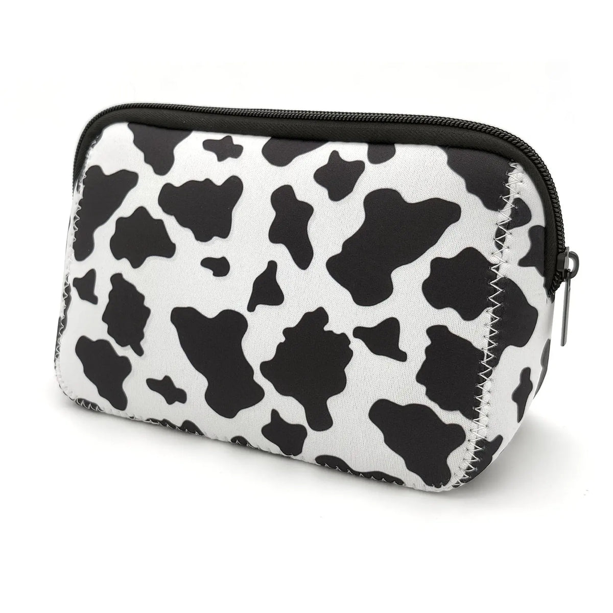 A black and white cow print cosmetic organizer bag with a zipper.