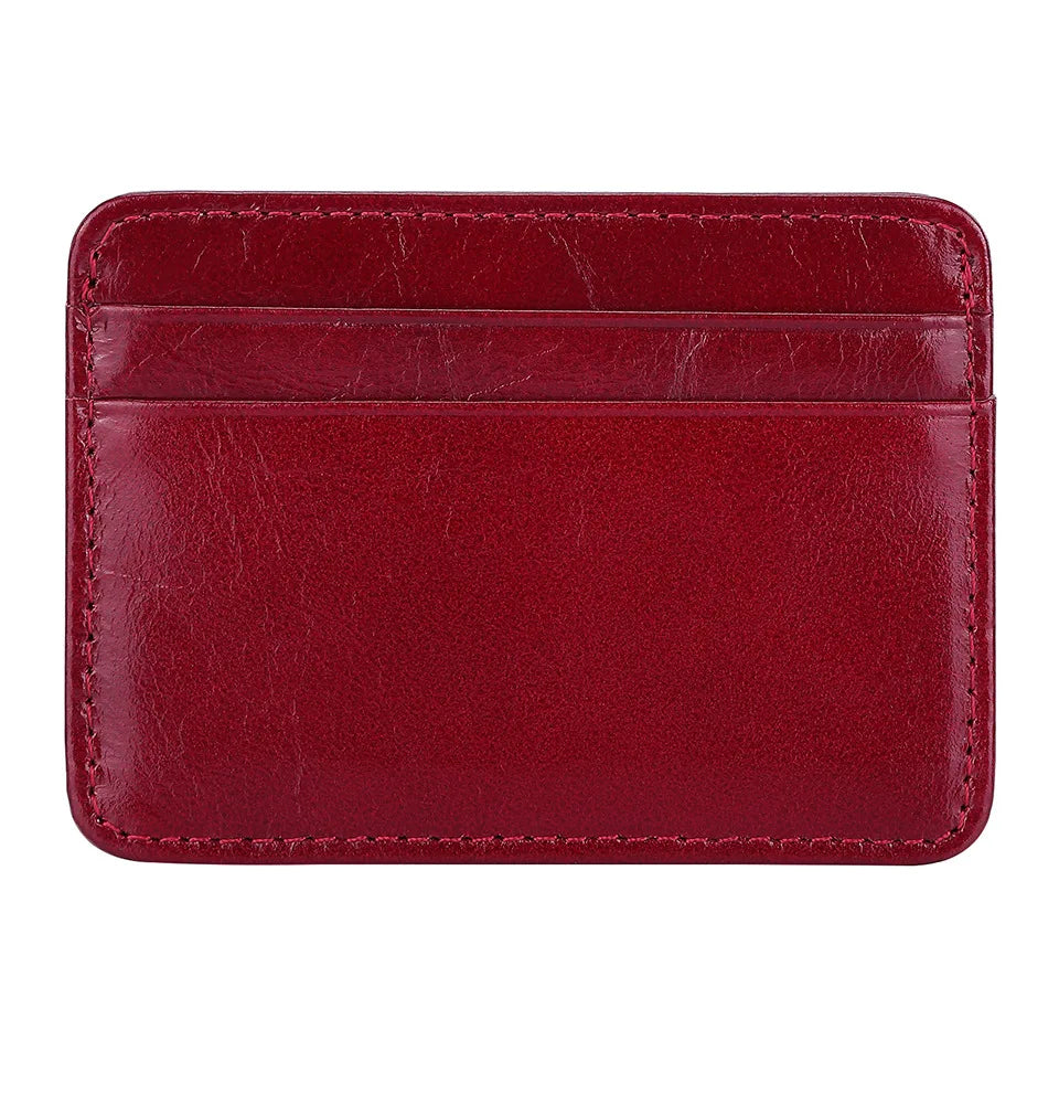 A deep burgundy genuine leather card holder with rounded corners.