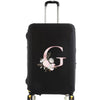 Black luggage with a pink floral monogram design on the side.
