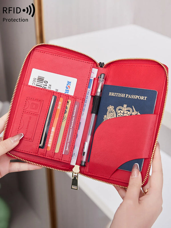 A red RFID blocking travel passport holder is shown open, displaying a British passport and various documents.