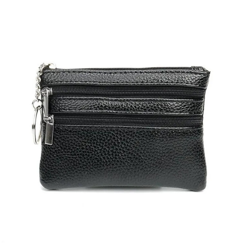 Black PU leather clutch wallet with zippered compartments and a chain detail.