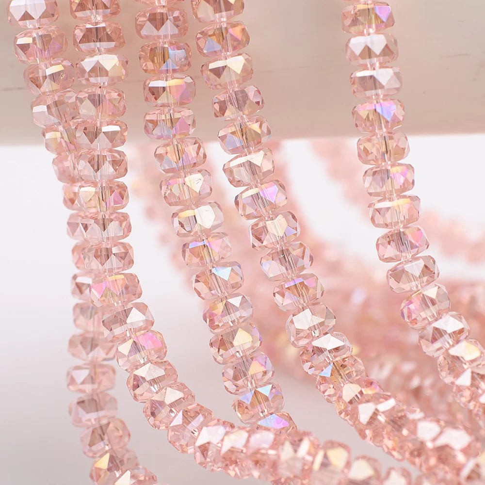 Pink AB faceted crystal glass beads in a wheel shape strung on a string