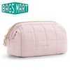 A light pink padded makeup bag with a quilted texture and gold zipper, shown against a white background.