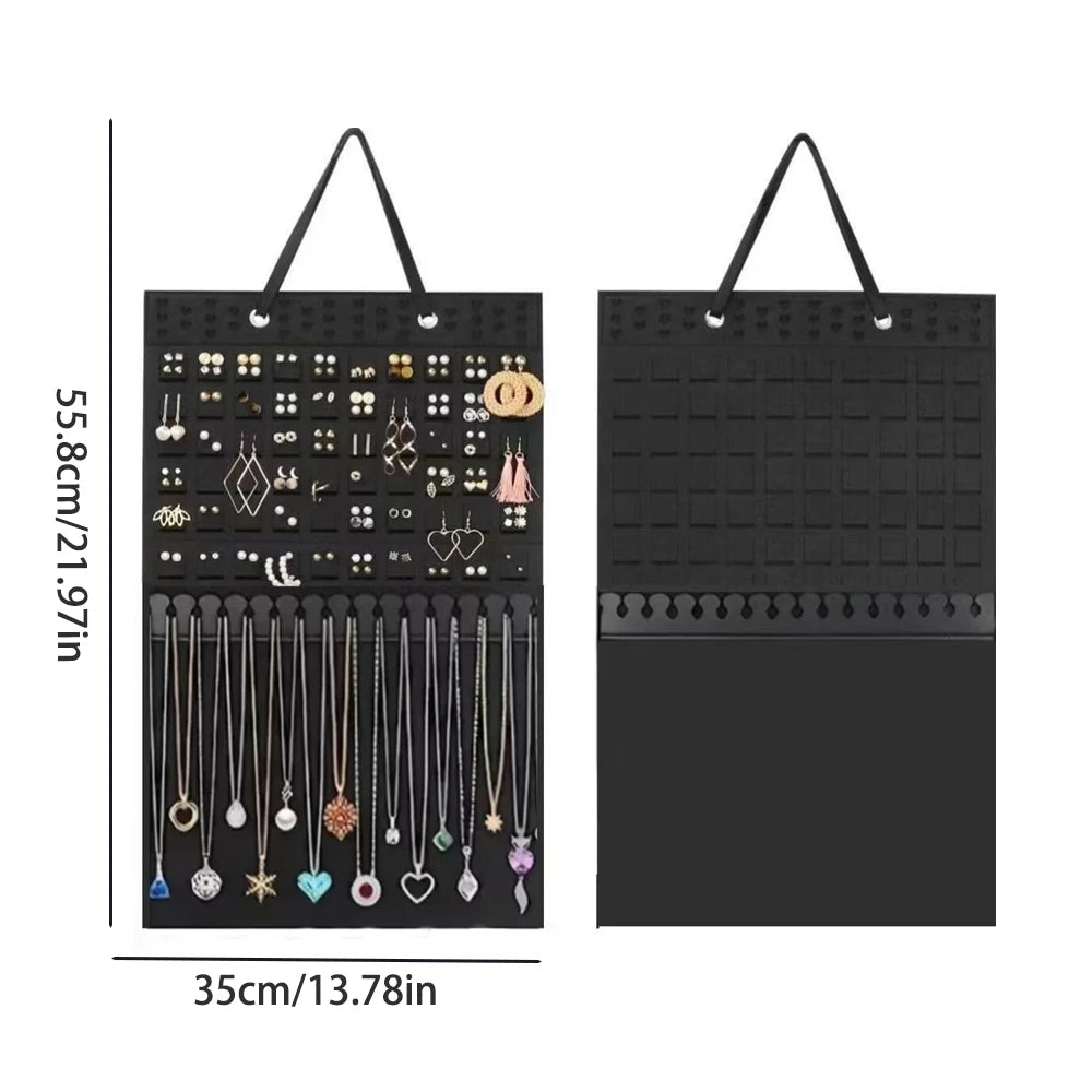 Black fabric jewelry organizer with multiple hanging slots for wall mounting