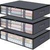 A set of three black under bed storage organizer bins with fabric lining and straps.