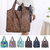 A collection of reusable shopping bags in various floral and patterned designs displayed against a white background.