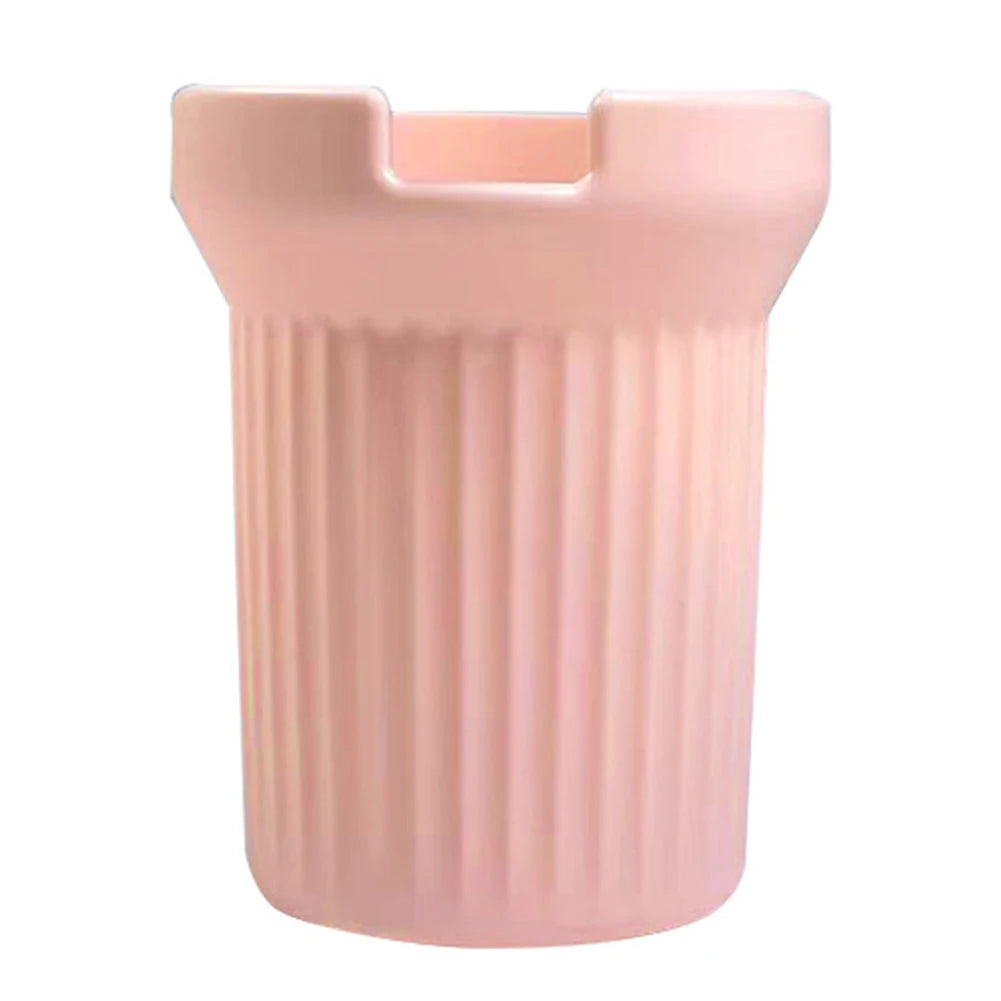 A pink silicone boot sleeve designed to fit water bottles.