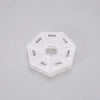 A clear, hexagonal pill organizer divided into seven sections labeled with the days of the week.