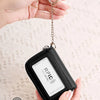 Black anti-fraud card holder wallet shown being held, demonstrating RFID protection technology.
