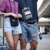 A person wearing a purple shirt and denim shorts is carrying an RFID blocking neck wallet for travel documents.