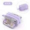 A purple multifunctional pencil case with multiple compartments and a matching zippered pouch.