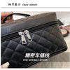 Close-up of a black quilted leather makeup storage pouch with silver zippers and hardware.