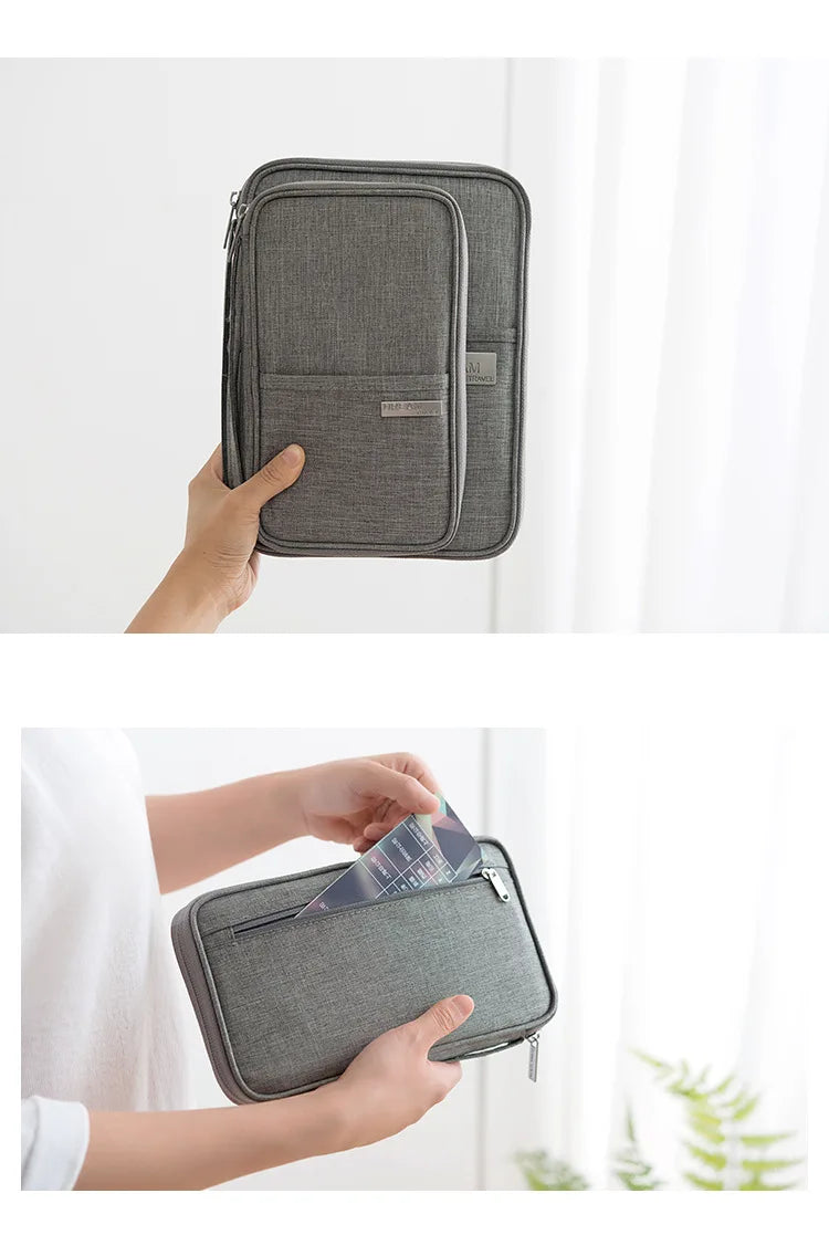 A gray multi-pocket waterproof travel document organizer is shown being held by a hand.